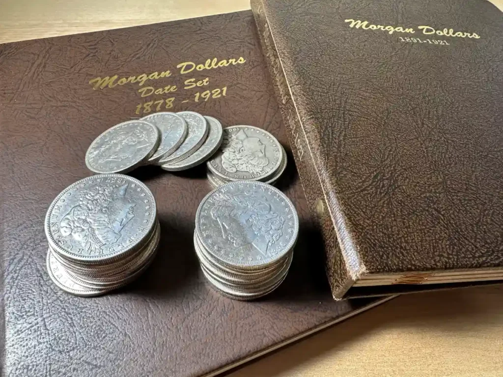 Close-up of a Morgan Silver Dollar coins placed on top of a collector's book, showcasing the coin's intricate details and historical significance.