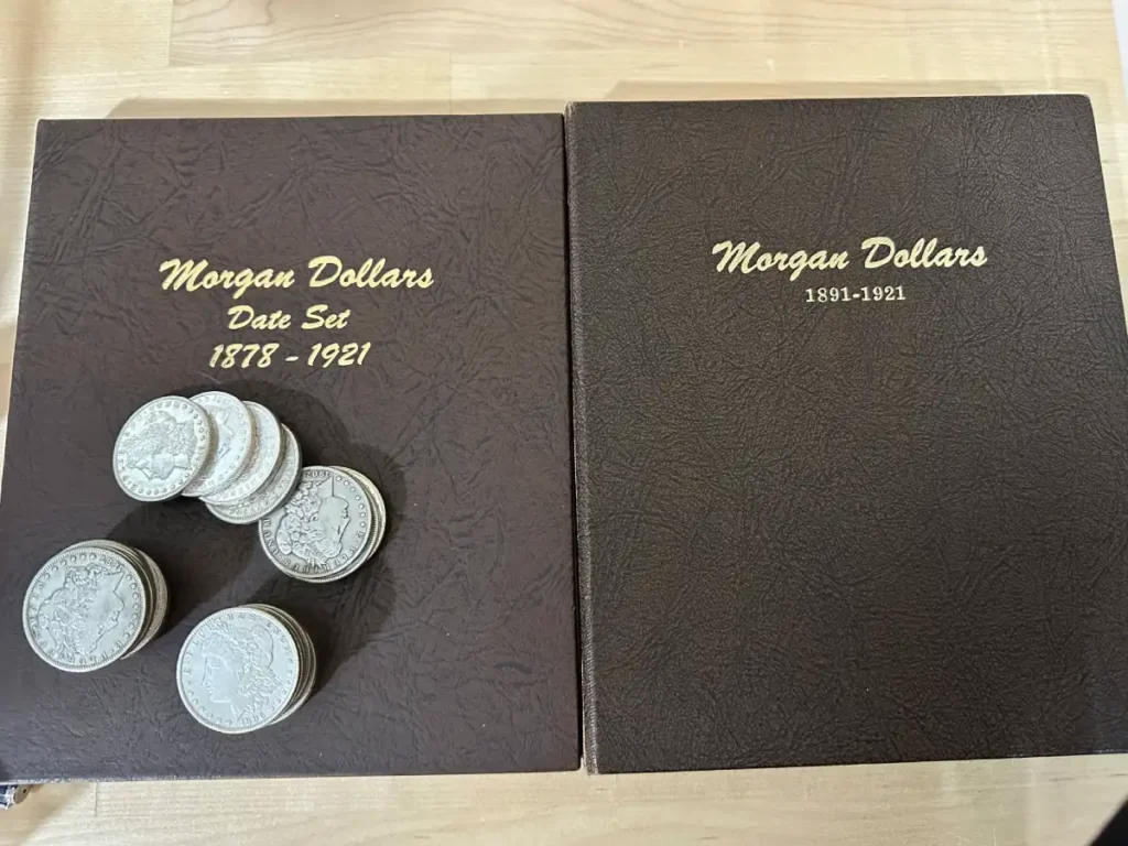 Morgan Silver Dollar coins arranged on top of a coin collection book, emphasizing their historical value and beauty