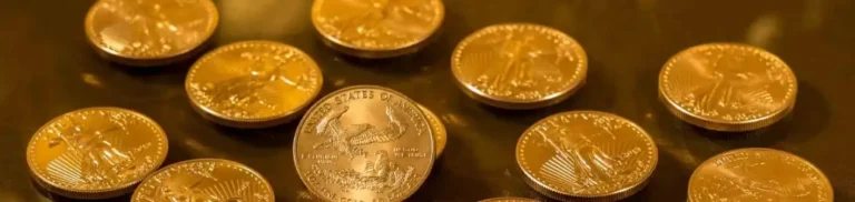Concise replacement alt text: A collection of gold coins, including one prominently displaying "United States of America."