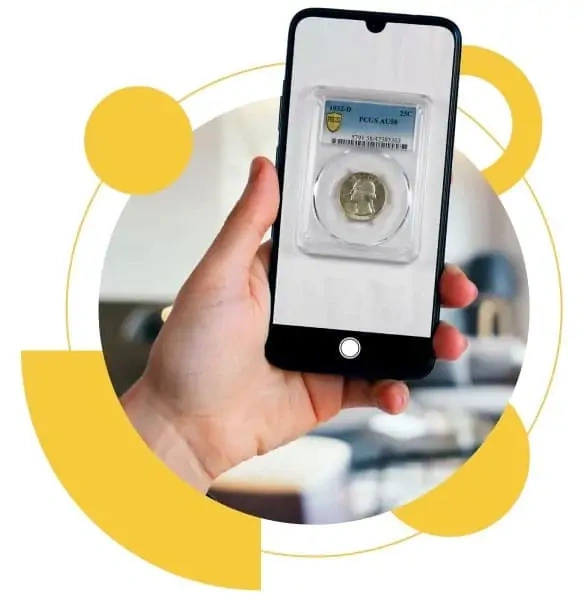 A hand holding a smartphone displaying a graded coin in a protective case.