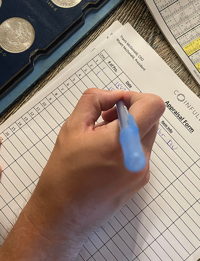Filling out an appraisal form with a blue pen, showing a hand and a partially visible list of items.