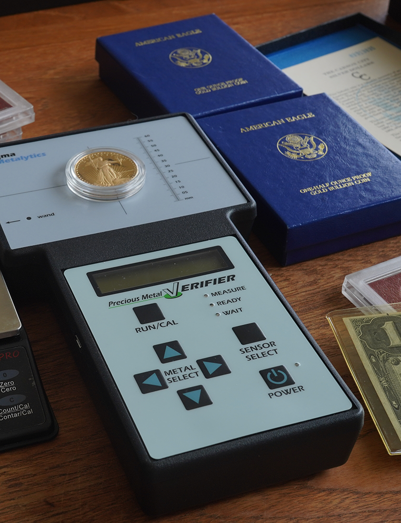 Gold coin on a metal verifier device