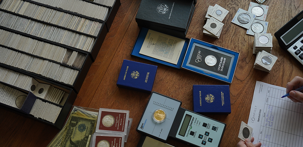 Inherited coin collection displayed on a table, including coins and books