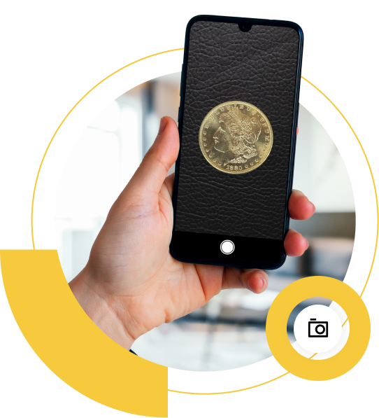 A hand holding a smartphone displaying a gold coin on a black background